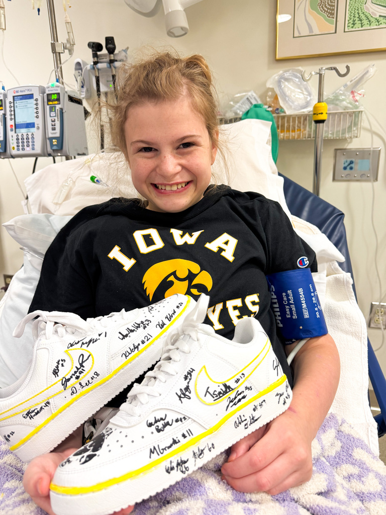 Gianna holds Nike Shoes