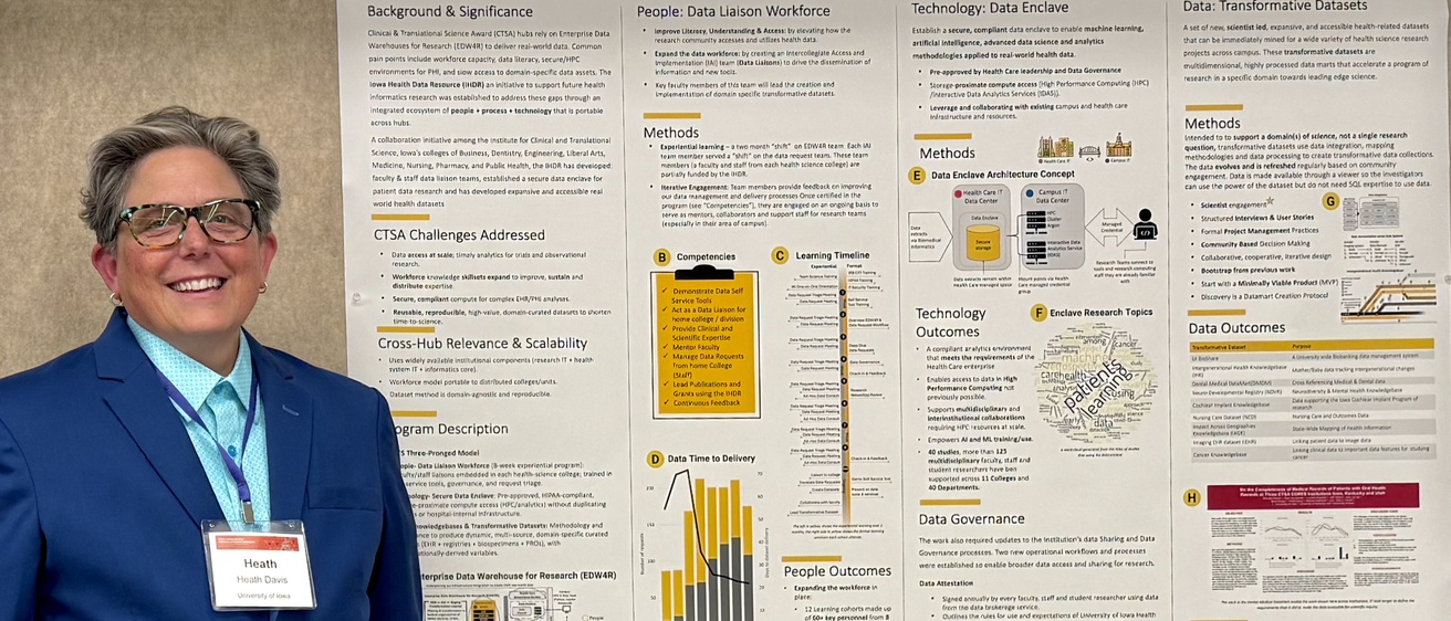 Heath Davis stands with Iowa Health Data Resource Poster 